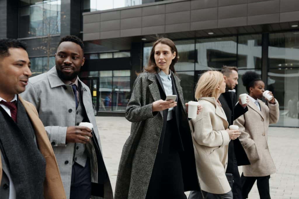 Business People Walking Outside with Coffee