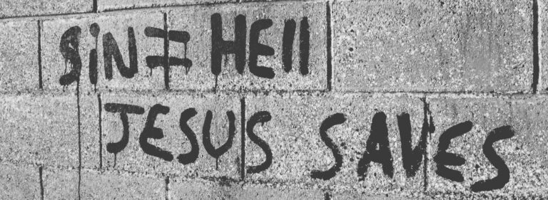 Writing of the words sin equals hell, Jesus saves