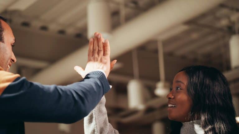 A man and woman high fiving